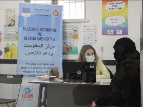 IGAM staff assisting Syrian refugee woman 