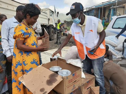 World Vision Staff member distributes food