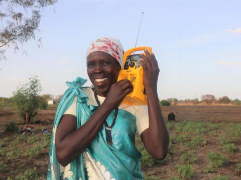 Woman listens to the radio in Africa