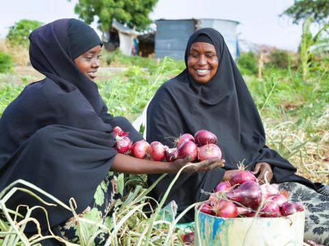 women with onions from their garden