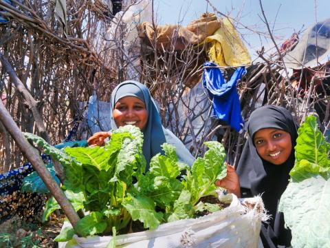 Women with leafy green vegetables