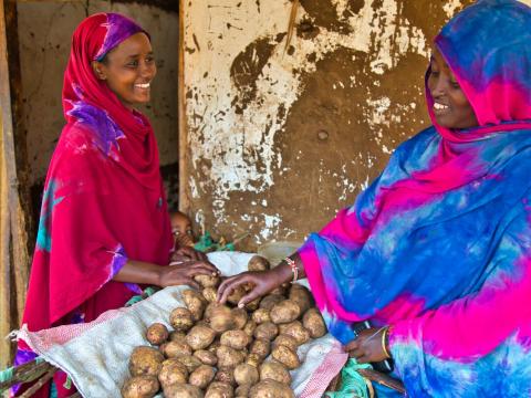 women buy and sell produce 