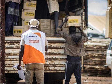 World Vision staff help distribute food