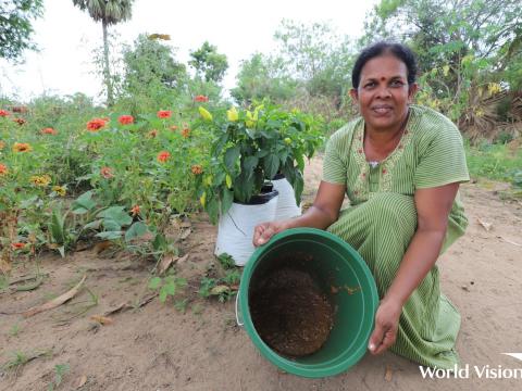 A woman in Sri Lanka shows her harvest