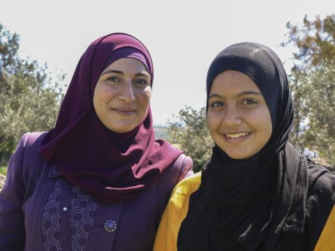 mother daughter and bee keepers smiling at the camera