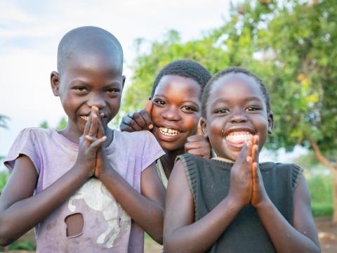 Children praying and smiling