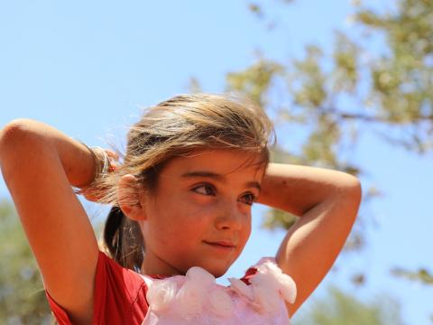 Syria girl against a blue sky