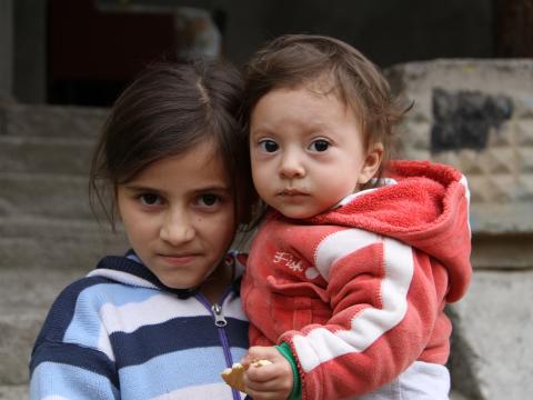 Child and baby in Armenia looking at the camera 