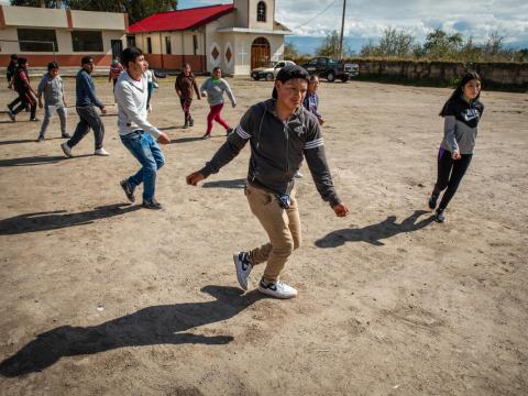 Sponsored child in Peru dances with the dance group he helps lead as part of child sponsorship activities