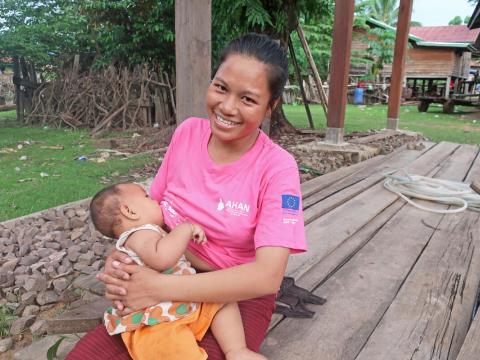 Mother baby breastfeeding Asia smiling