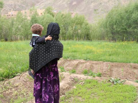 Woman in Afghanistan holds baby