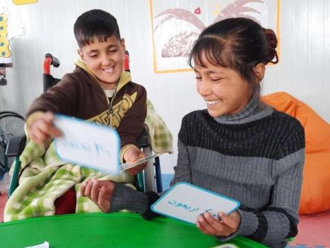 Khaled with his sister Lina learning with flash cards