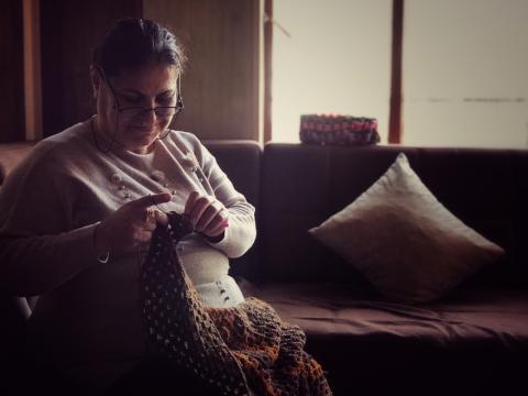 Montaha knitting In her home