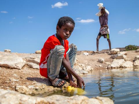A ten-year-old boy withdraws water in Puntland, Somalia