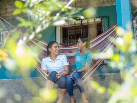 Danesi sits in a hammock with a friend