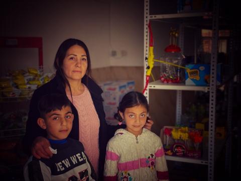Azia in her store with her children
