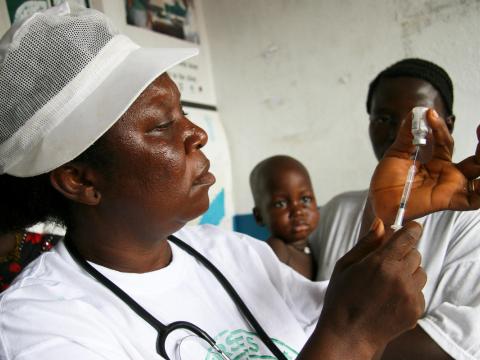 Nurse Sando Fisher prepares an injection at a World Vision supported clinic in Bagbo ADP Sierra Leone