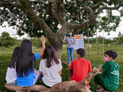 Sponsored child teaching other children