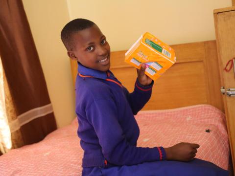 A girl in Rwanda showing pads in the Menstrual hygiene room