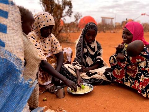 Family eating lunch from a shared bowl 