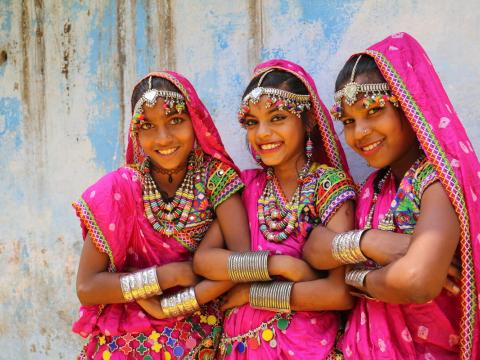Varsha and her friends, Shivkanya and Gareema, dressed in traditional costumes in India.