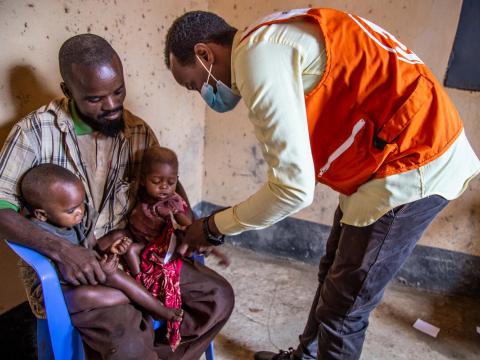 World Vision staff member in Somalia checks the upper arm circumference of children to check for malnutrition
