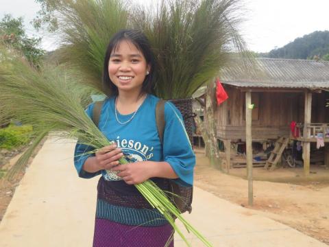 Xa stands holding a plant