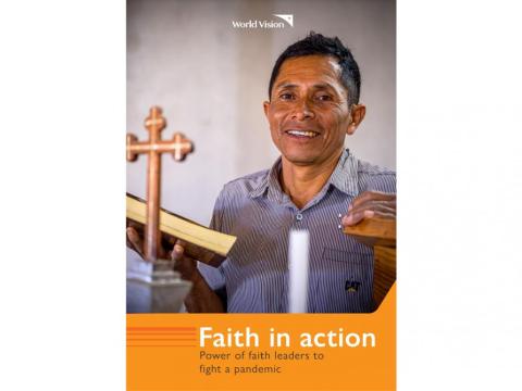 man stands behind a pulpit holding a Bible