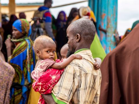 A father comes to a World Vision clinic in Baidoa, southern part of Somalia to receive support for his malnourished kids. 