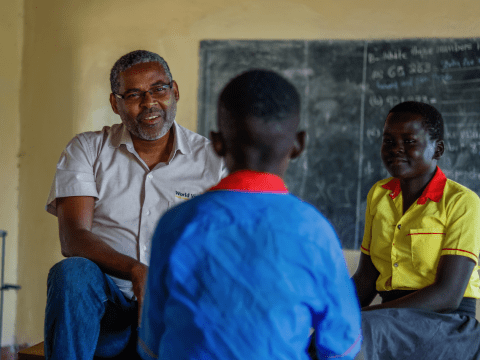 Mesfin Loha, World Vision's country director for South Sudan, speaks with school children