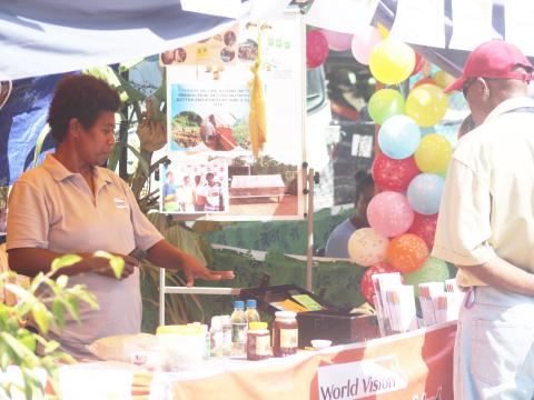 Roselyn Baku MERMAID Project Manager talking to visitors to WVSI Booth