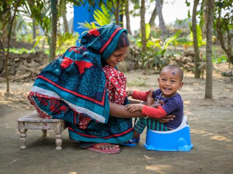 Shamoli, 25, helps her 1-year-old son learn about proper sanitation in Bangladesh thanks to the gift of a a hygienic latrine and baby toilet.