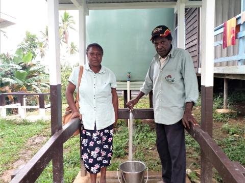 Sr. Maureen Damela (left) and a WASH Committee member testing the newly installed tank.