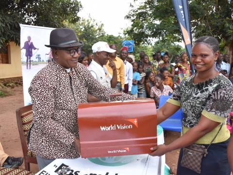 A beneficiary receiving her machine from World Vision