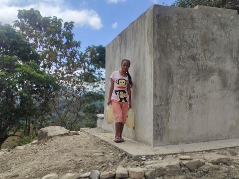 Maria is fetching water in the new water spring.