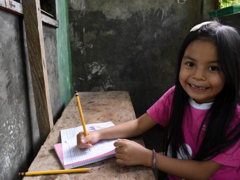 6-year-old sponsored child Glea learning how to read and write