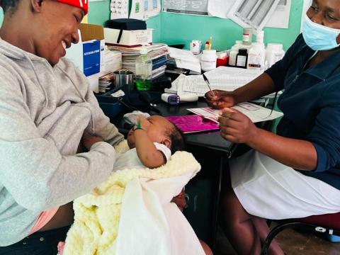 A mother brings her daughter for a medical checkup at Silozwe Clinic.