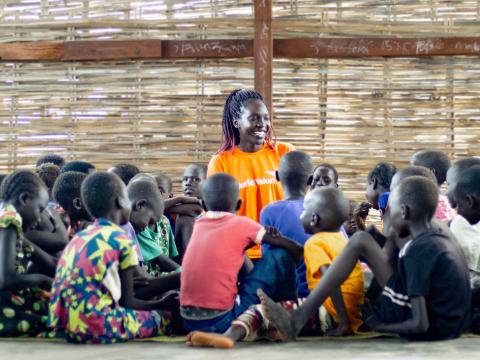 Woman in South Sudan surrounded by children
