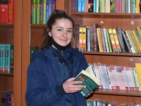 Mirjeta reading a book