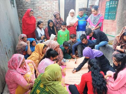 a group sitting in a circle having a meeting