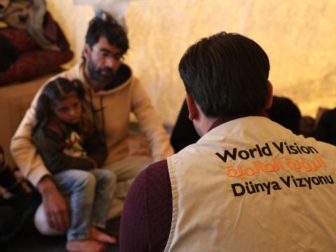 Yahya and his daughter after escaping the deadly Syria earthquake with World Vision staff.