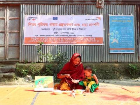 a mother feeding her child during a nutrition demonstration session