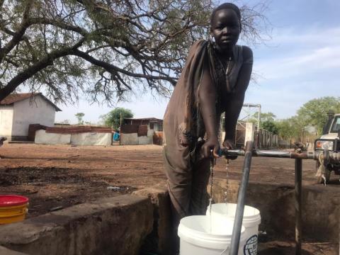 Girl fetches clean water from one of the water