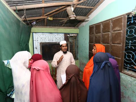 a group photo, a faith leader counseling a group of women