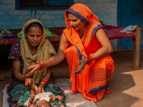 Community health worker helping mums in india