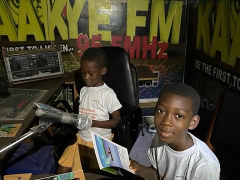 Samuel, first (right) reading story book at Kaakye FM 