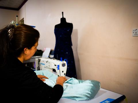 Maisun sewing in her home 