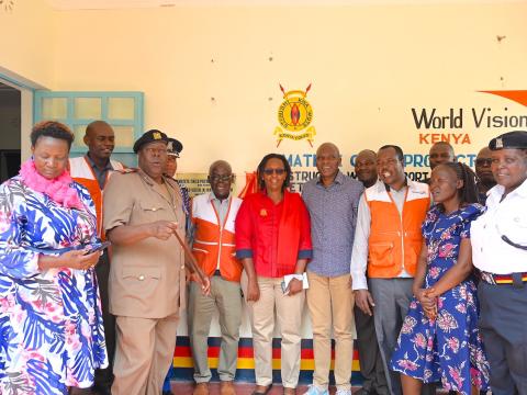 World Vision staff, Kenya Police Service representatives, County government officials,  among other stakeholders pose for a picture outside the Child Protection Unit that was constructed through the support of World Vision, within the Matete Police Station. 