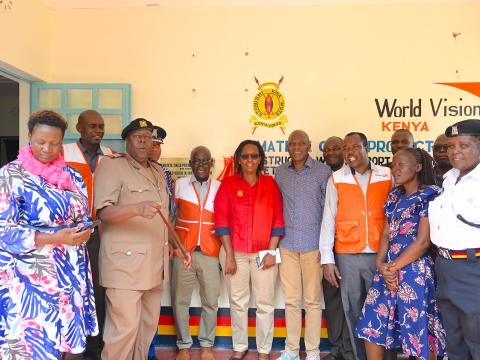 World Vision staff, Kenya Police Service representatives, County government officials, among other stakeholders pose for a picture outside the Child Protection Unit that was constructed through the support of World Vision, within the Matete Police Station.