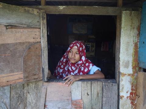 In Mindanao, Philippines, Shuhaira, 16, Grade 8 student from Cotabato City, looks through a window at her house